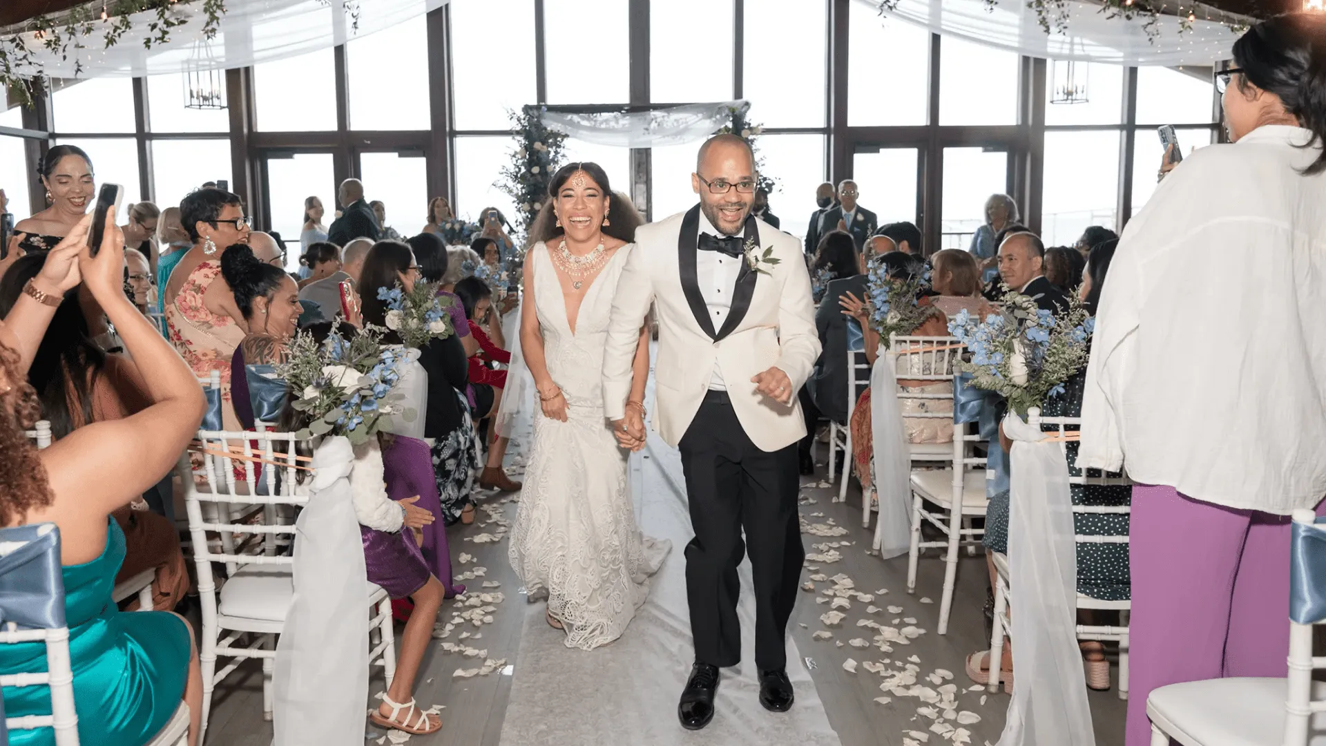 Joe and Rosa walking down the aisle after their wedding ceremony