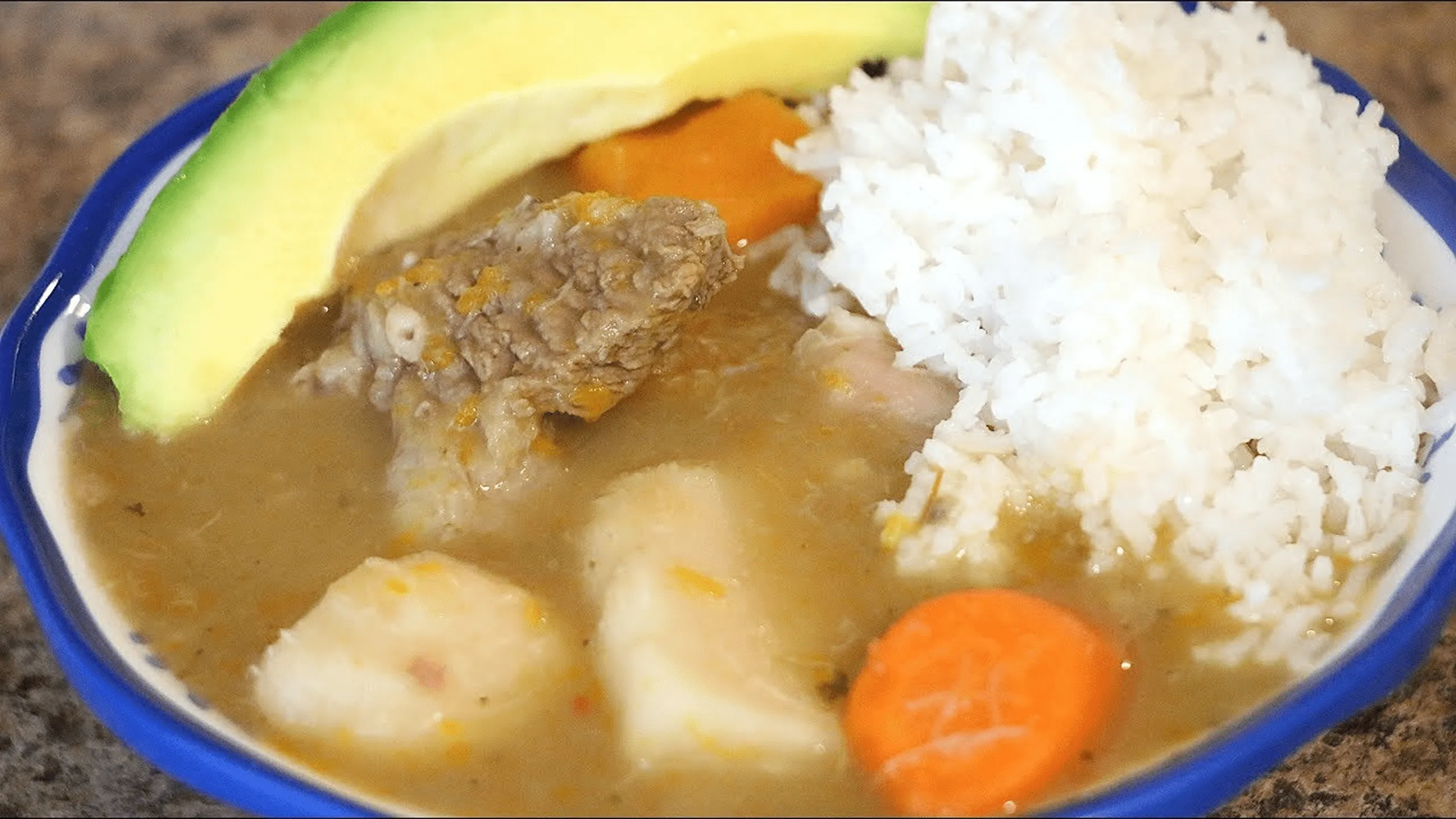 Screenshot of Sancocho a Dominican stew with assorted meats, rice, and root vegetables.