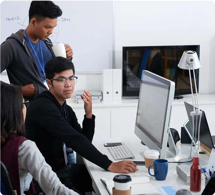 three people in front of the computer