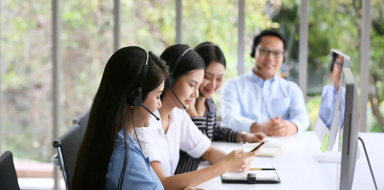 a line of people in front of computer