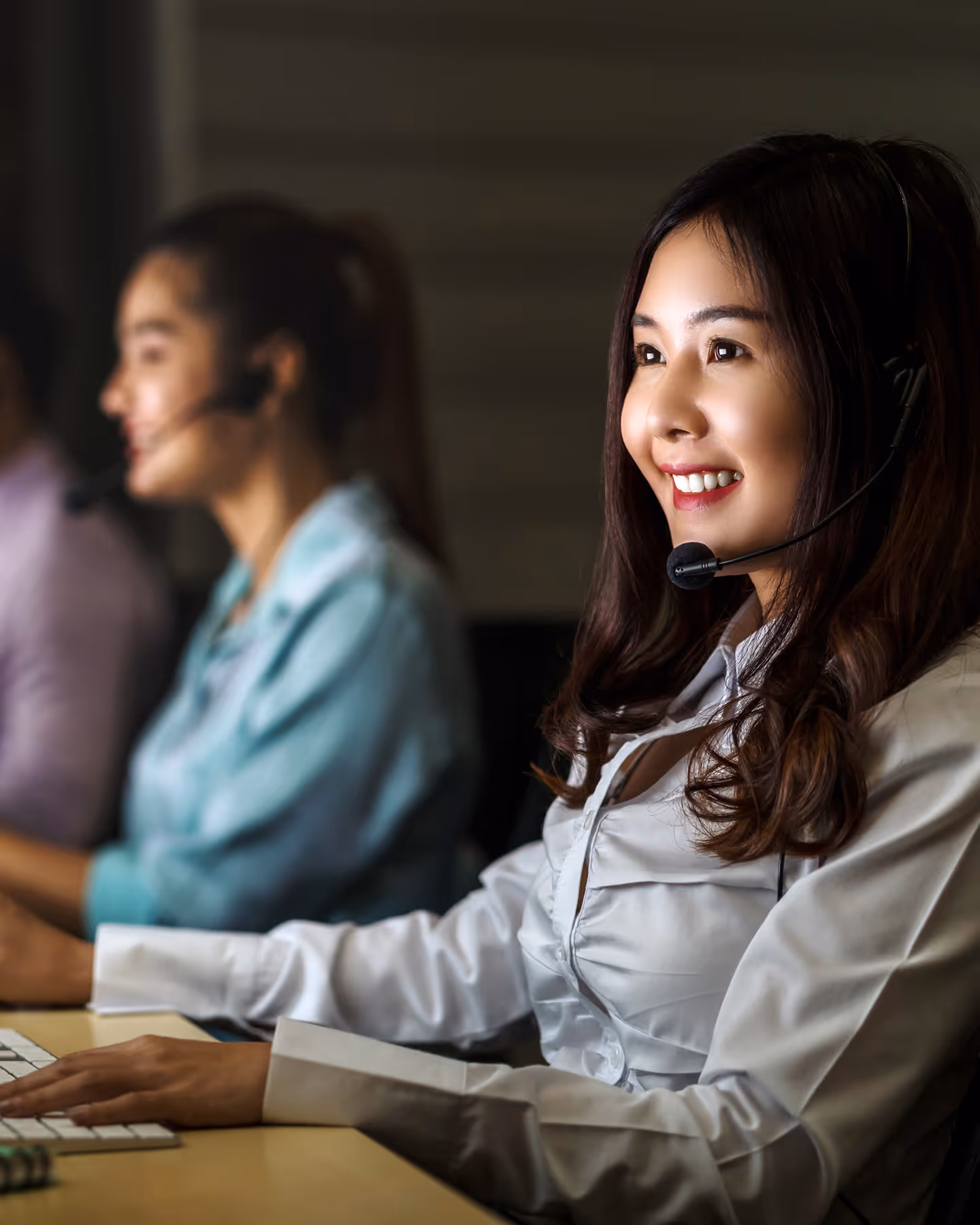 a smiling woman with headset