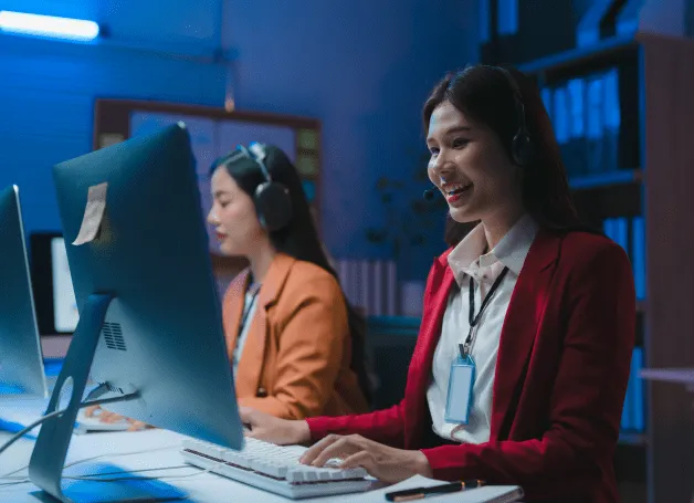 Two woman using computers