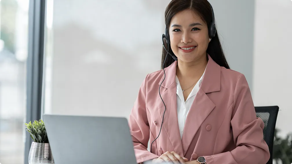 Woman wearing pink formal dress with a laptop in front