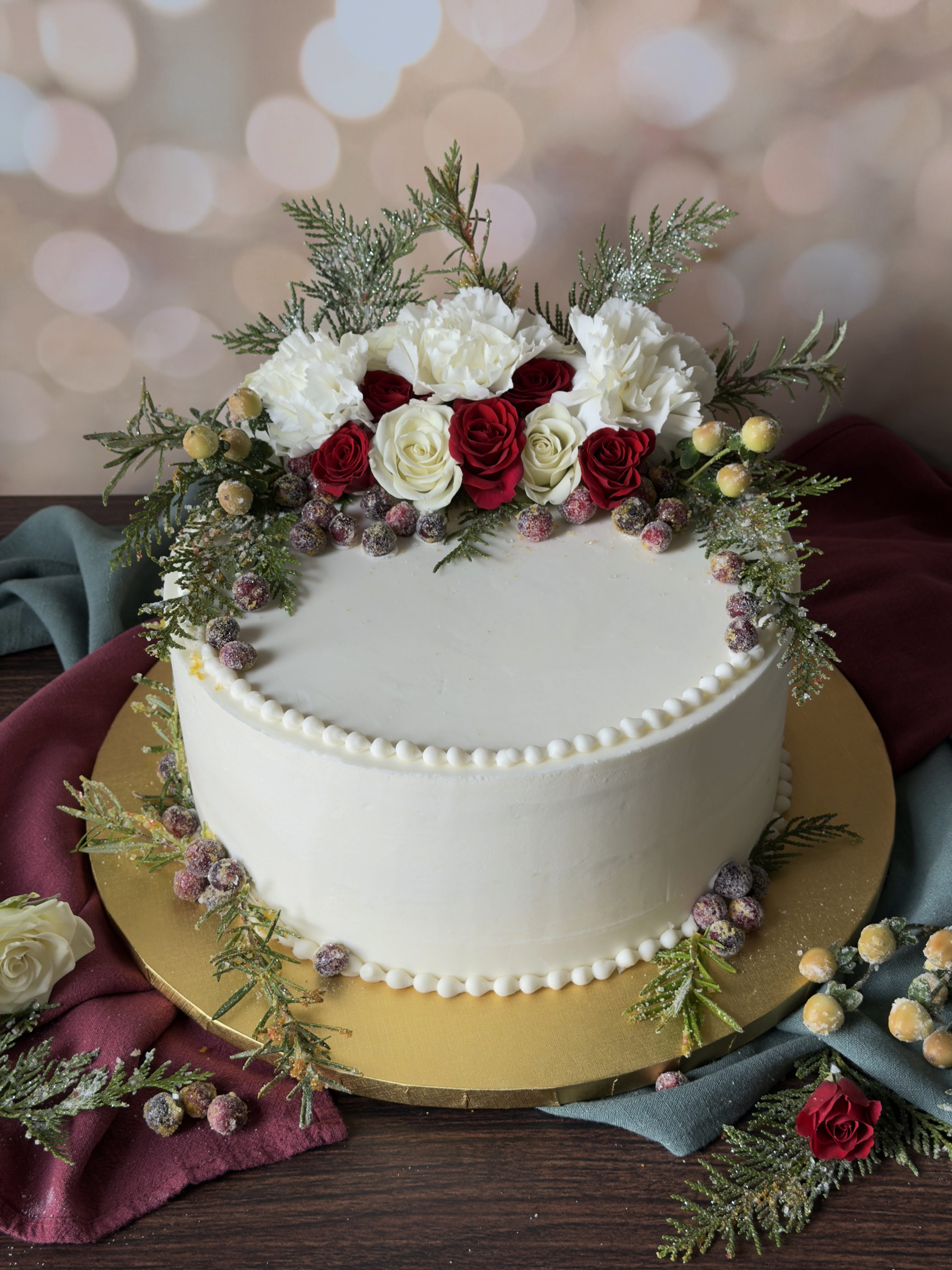 Baked to perfection in Van Alstyne, Texas! This cake is decorated with Christmas and season fresh flowers that are dusted in snow sugar. 