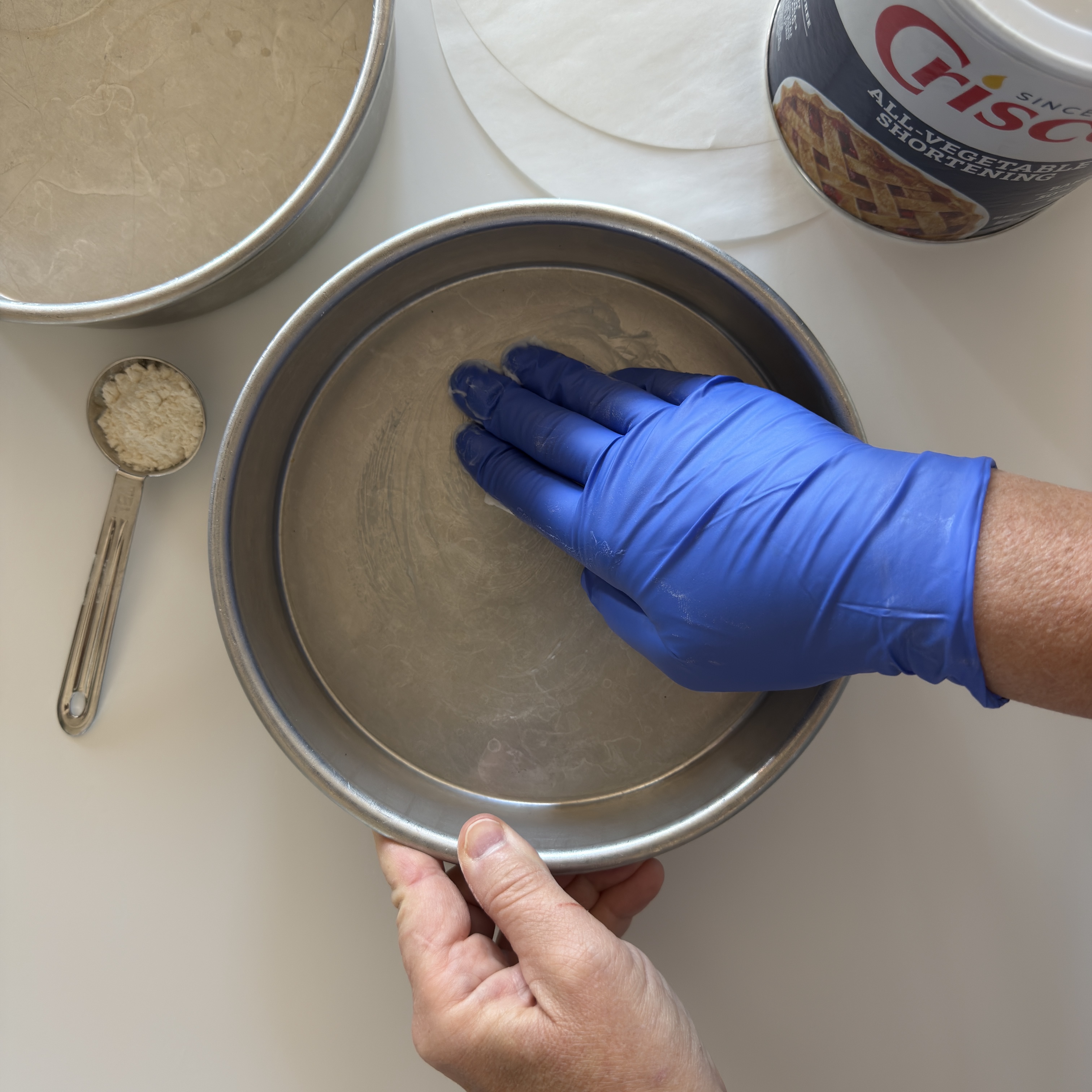 It is easy to prepare a a cake pan with shortening. Crisco is a great all purpose vegetable shortening.