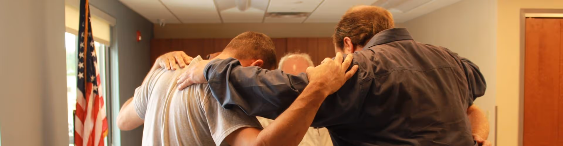 Group prayer session - 5 men lead by counselor