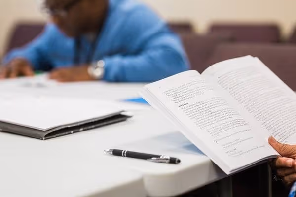 2 men reviewing their material during bible study
