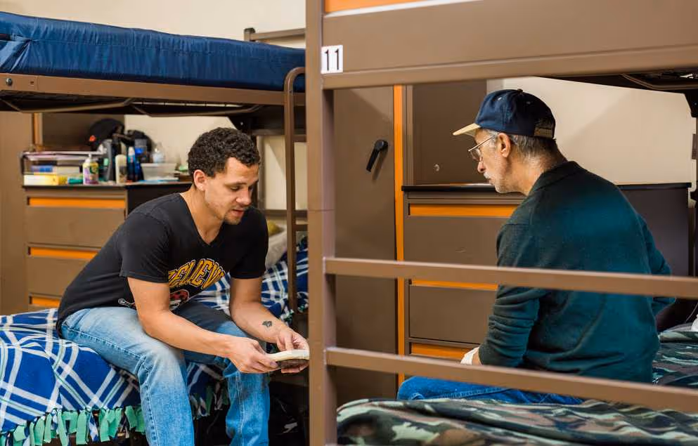 Two men in the City Mission's Men's Shelter have a recovery meeting
