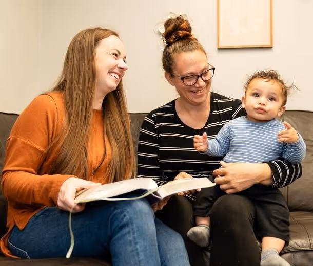 resisent and staff member smile for photo