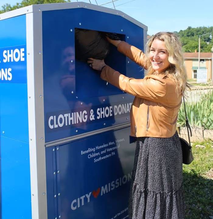A generous male citizen stops at City Mission's Samaritan Care Center to drop off some goods