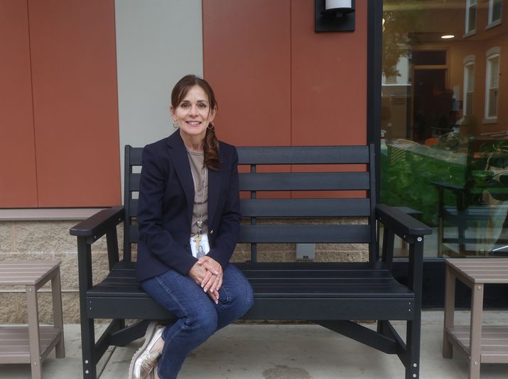 Diana Irey Vaughan, President and CEO of City Mission, seated on a bench