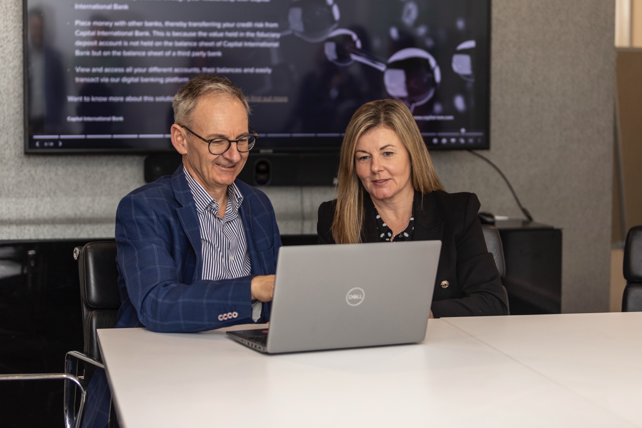 Two colleagues working together on a laptop