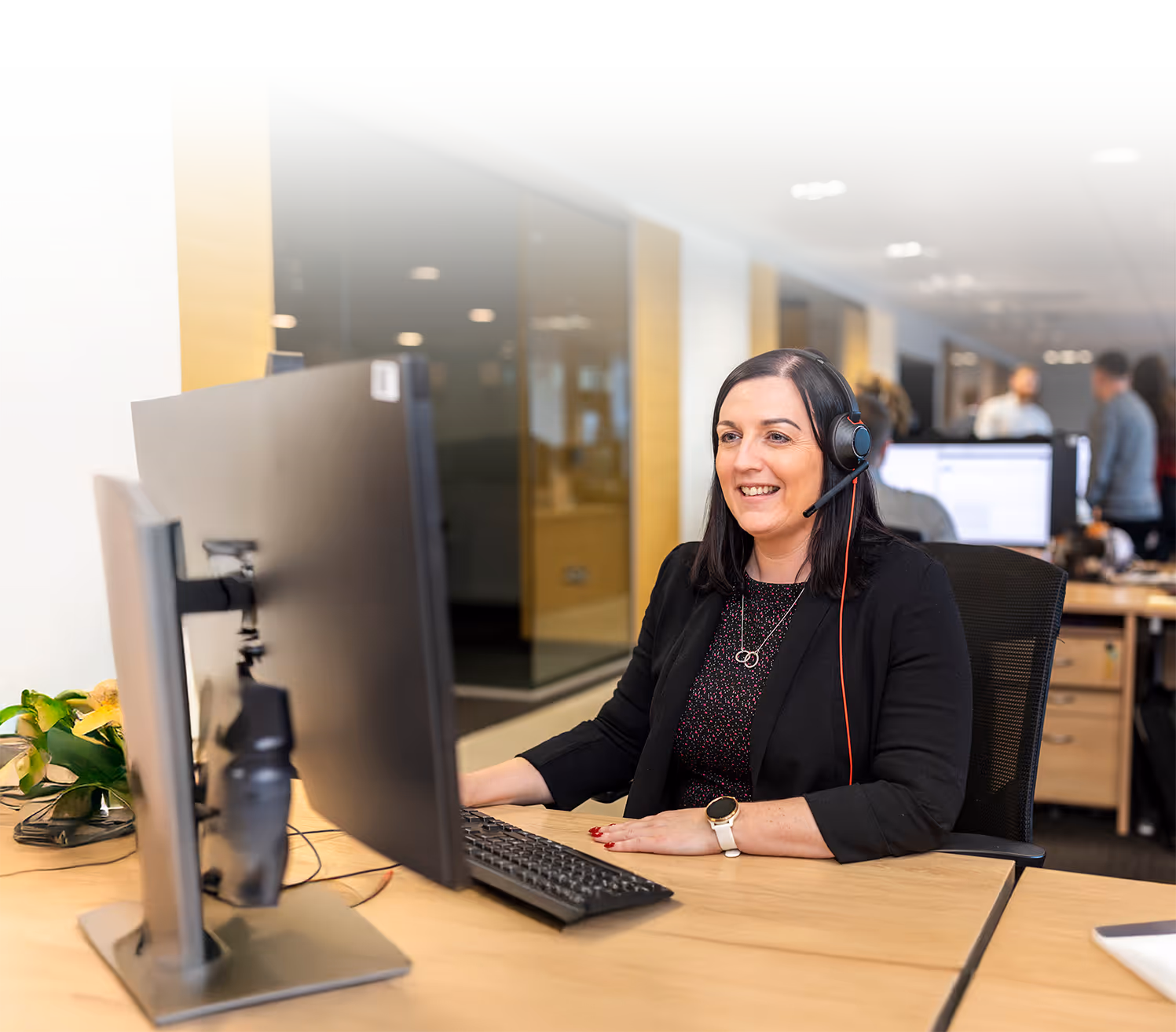 A Capital International team member talking to a client through a headset