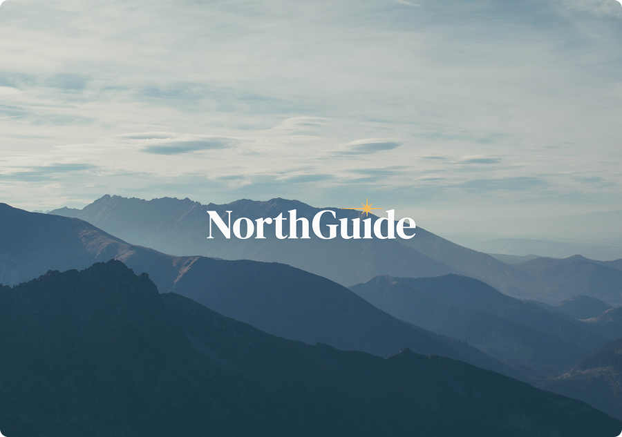 A picture of a mountain landscape with the words NorthGuide in the center