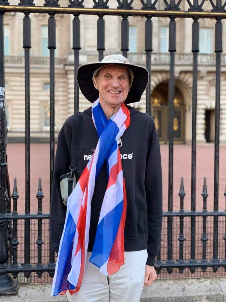 IDEA Services resident Bob Kemp wears Union Jack while visiting Buckingham Palace