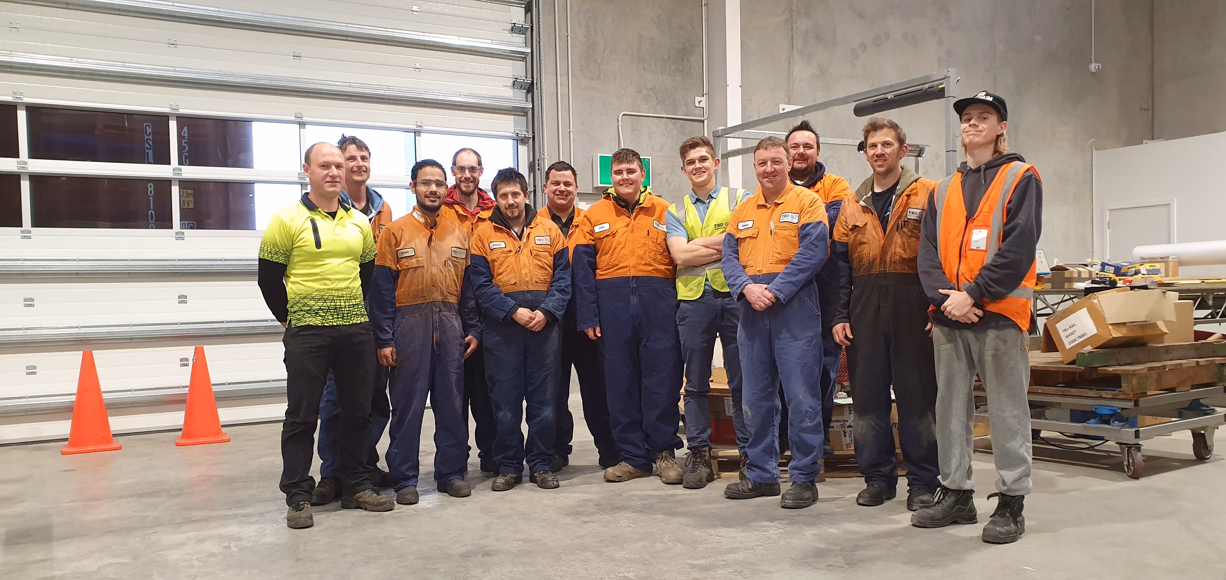 Jake Miller (pictured in centre) works with a IDEA Services vocational support worker to make a success of his job with Tru-Bilt Industries.