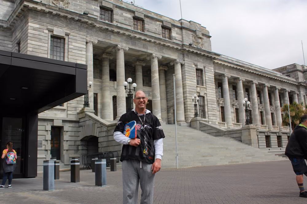 Tony Hofsteede stands outside New Zealand Parliament waiting for tour to start 