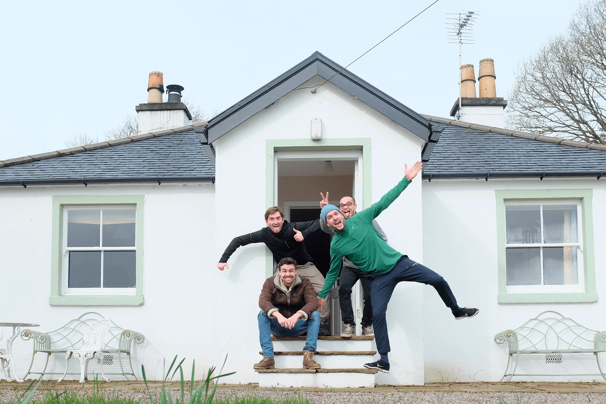 Homerun hiring software's founders and their first employee in front of a house in Scotland.