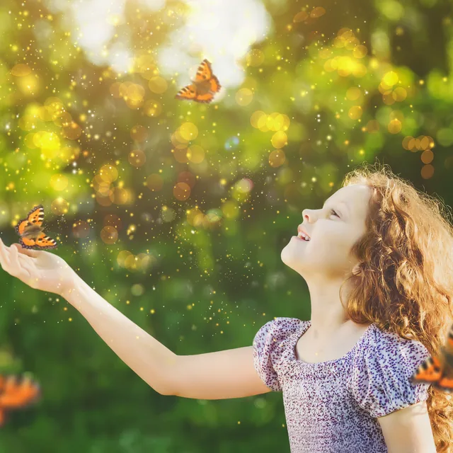 Mädchen mit Schmetterlingen im Sonnenlicht – Thema Coaching