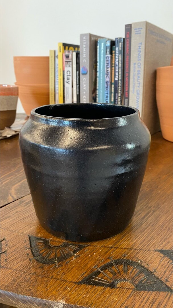A presenter at mountain workshops in front of a live audience of pods in a blackbox theater