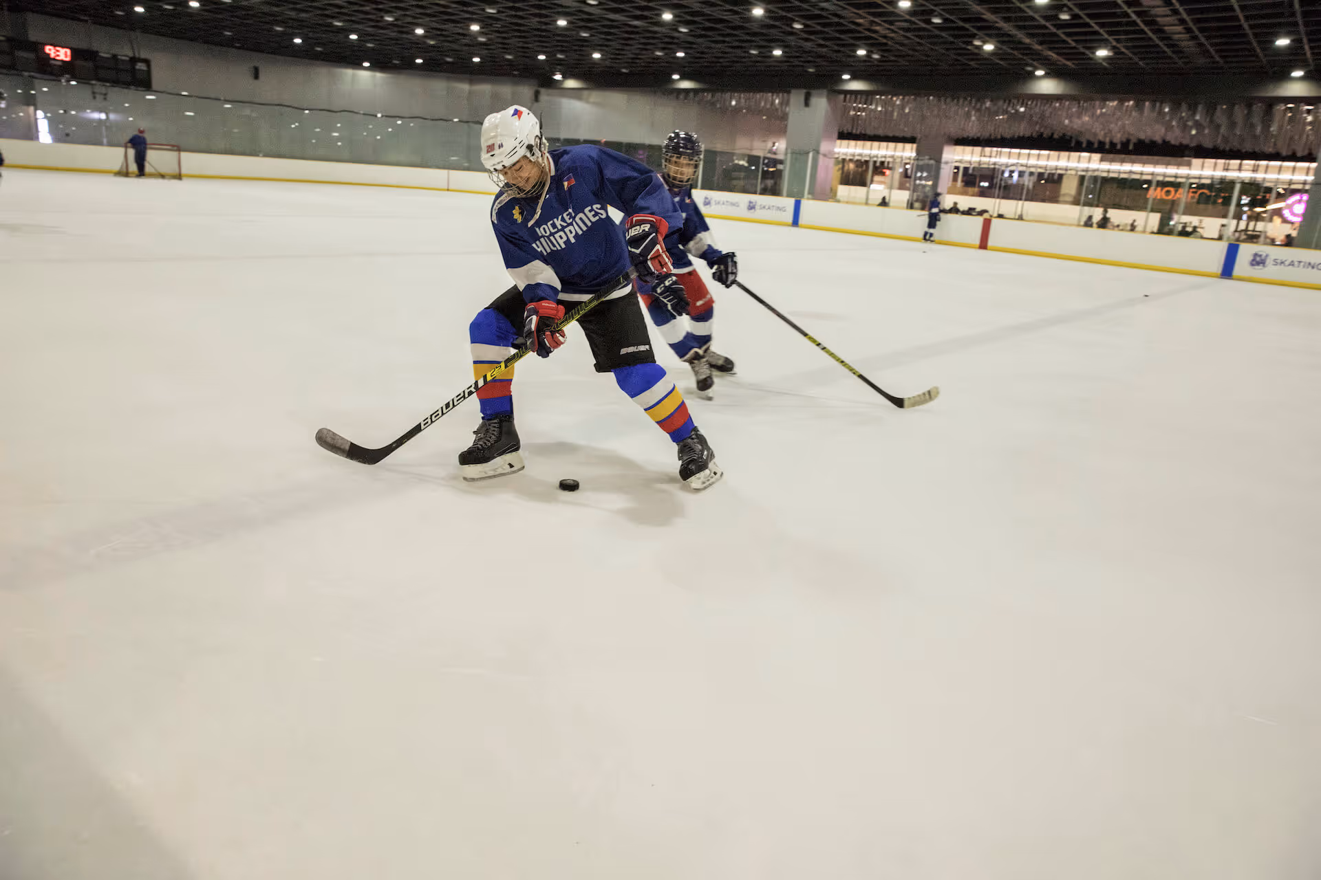 In a tropical country, a group of players and fans spend after hours in a mall, making the case for ice hockey.