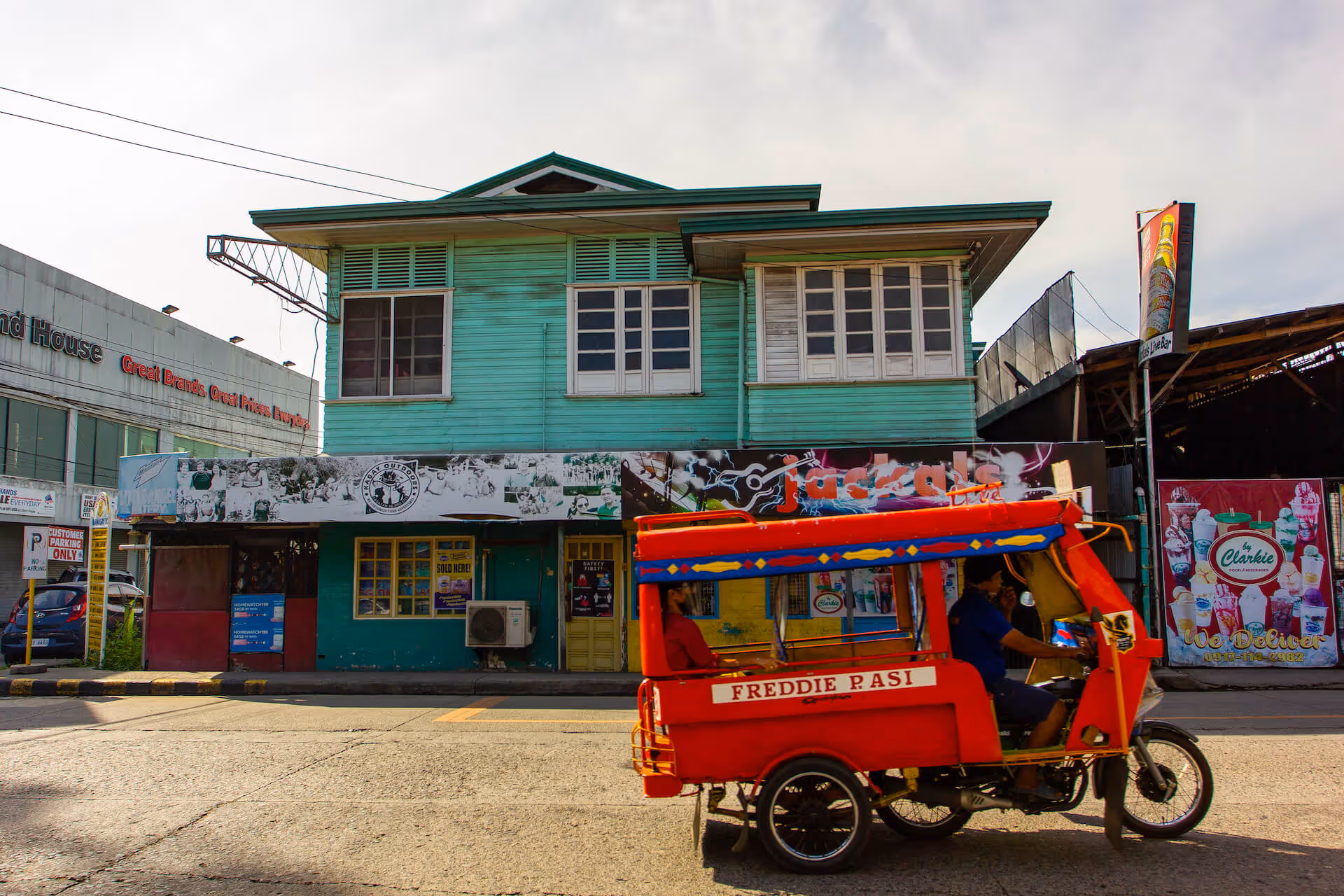 Cagayan de Oro's iconic motorela driving by a white water rafting office, photo by Earl Ryan Janubas