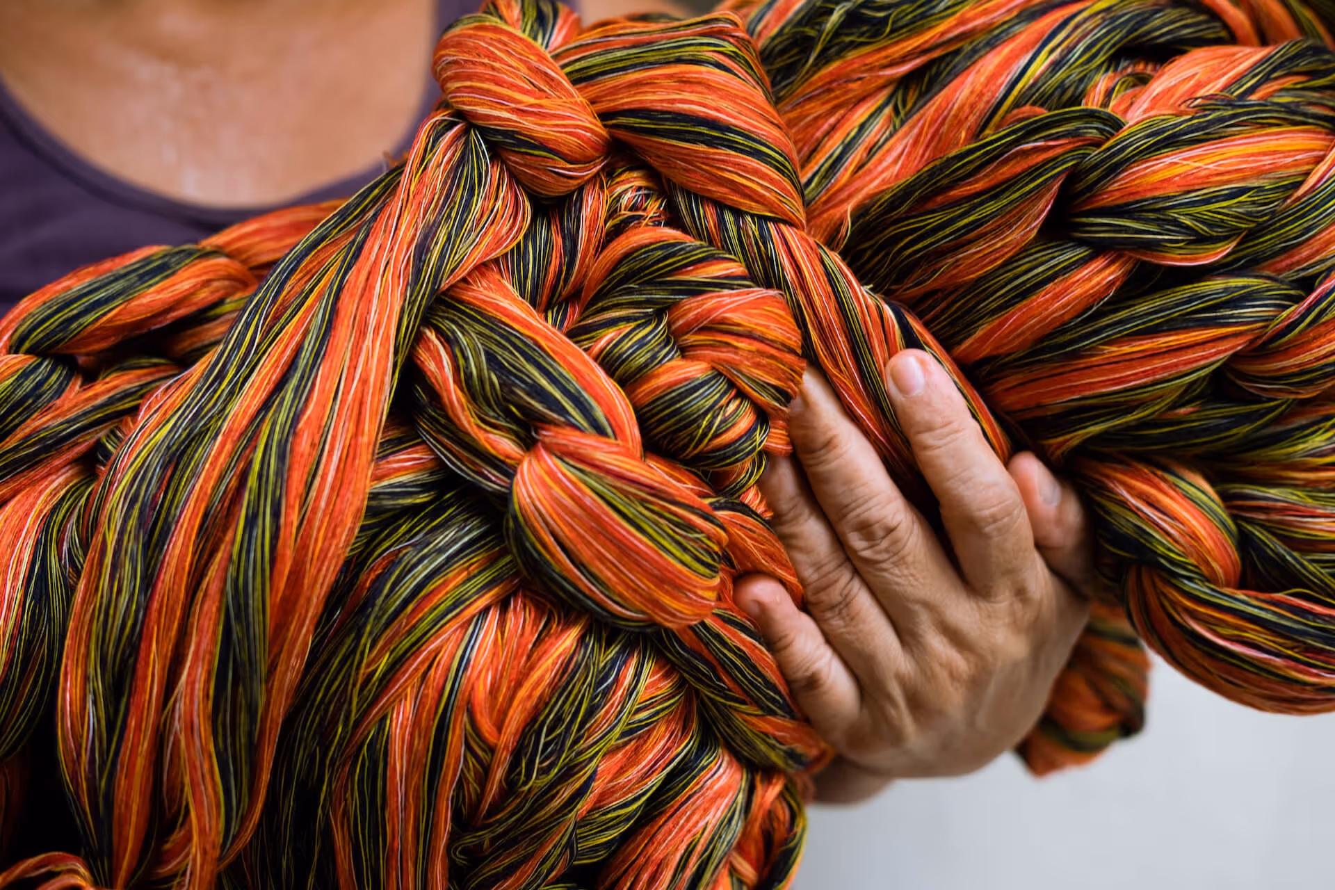 Weaver holding threads ready for the loom, photo by Fruhlein Econar