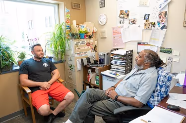 Housing Coordinator, Doug Bush with resident