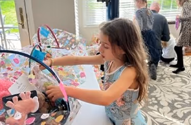 Natalie Grasso, age 7, prepares an Easter basket for a child in our Women with Children Shelter