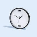 An analog clock with only two symbols instead of twelve: the symbols read 'AM' and 'PM'.