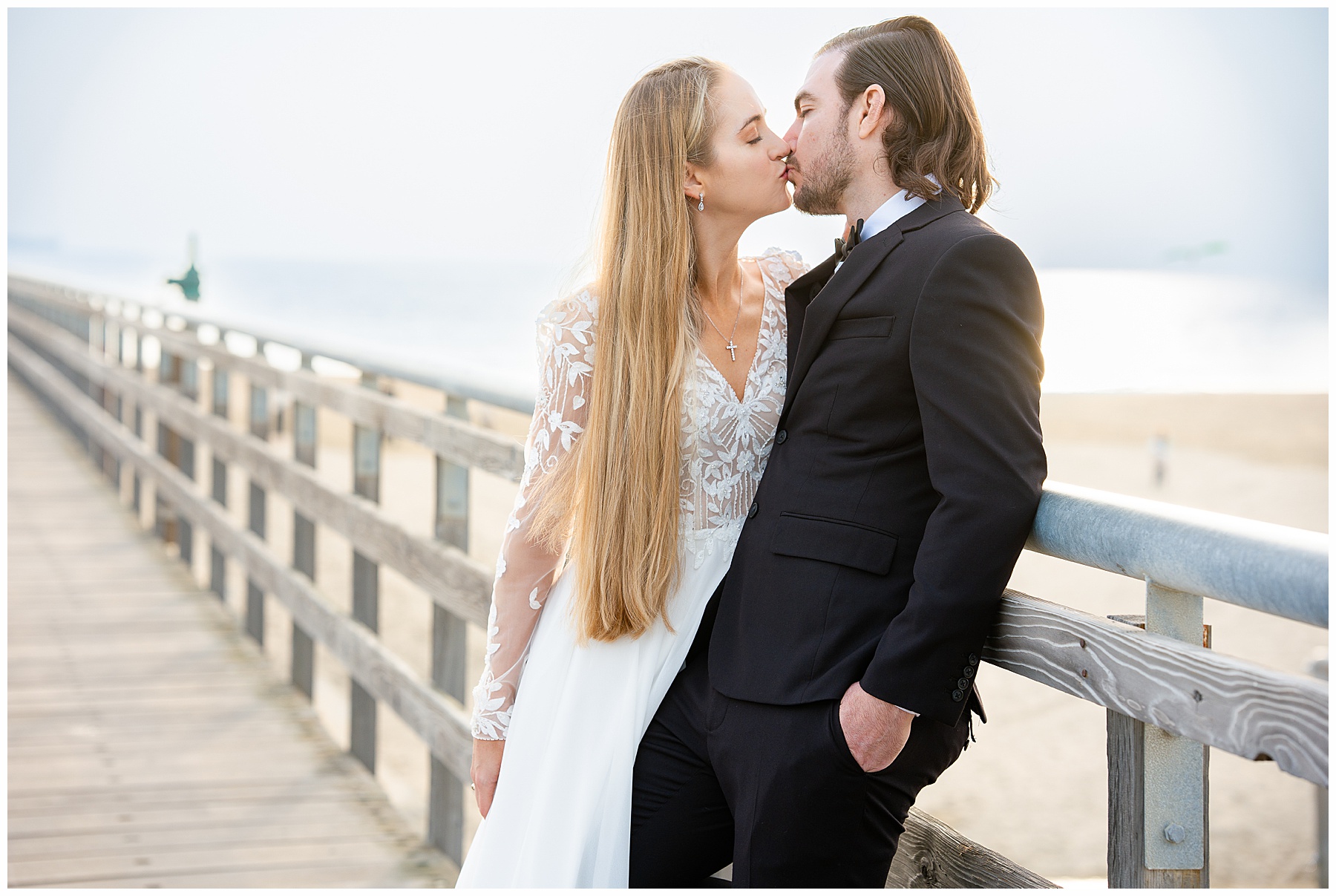 Romantic Seal Beach engagement portraits with a second-hand white dress, fitted white gown, and classic black suit. Coastal wedding photography with playful movement.