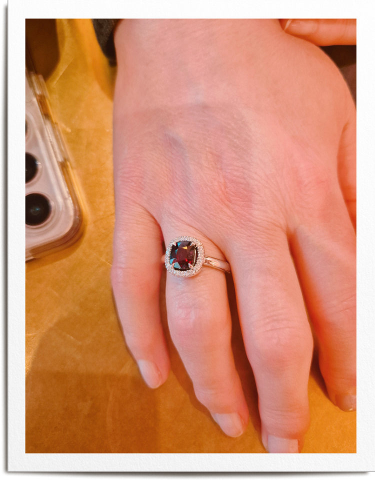 Woman's hand wearing ring with red stone. She has enlarged knuckles and ring fits perfectly.