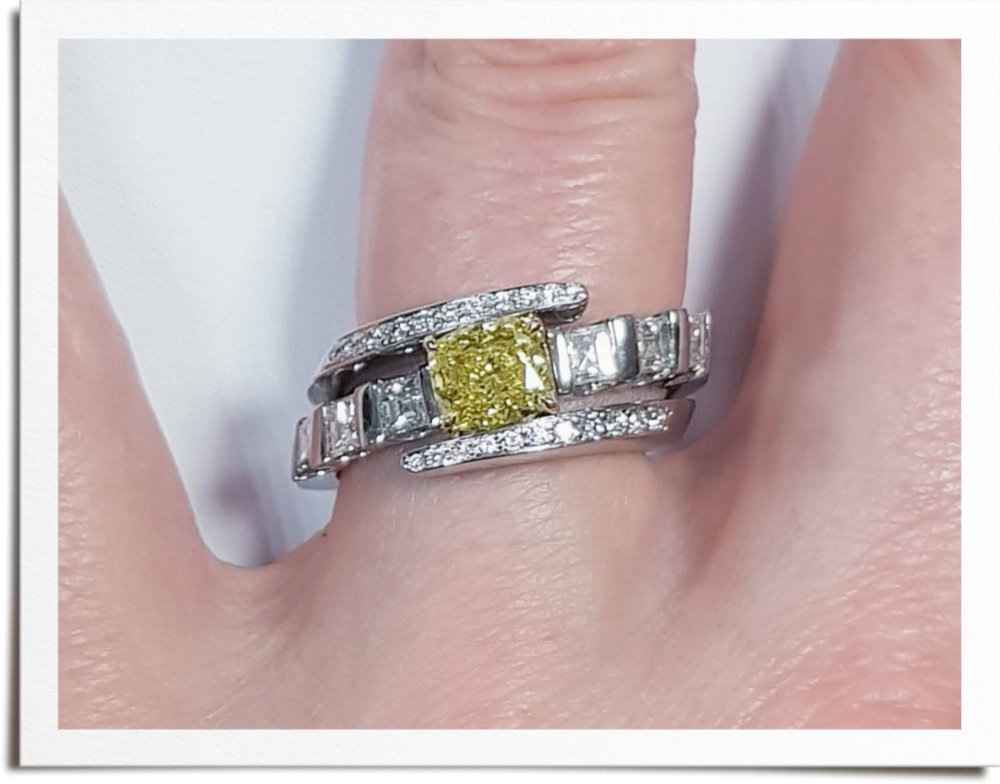 Yellow cushion shape diamond in crossover setting with the wedding ring either side of yellow diamond, set with square claws