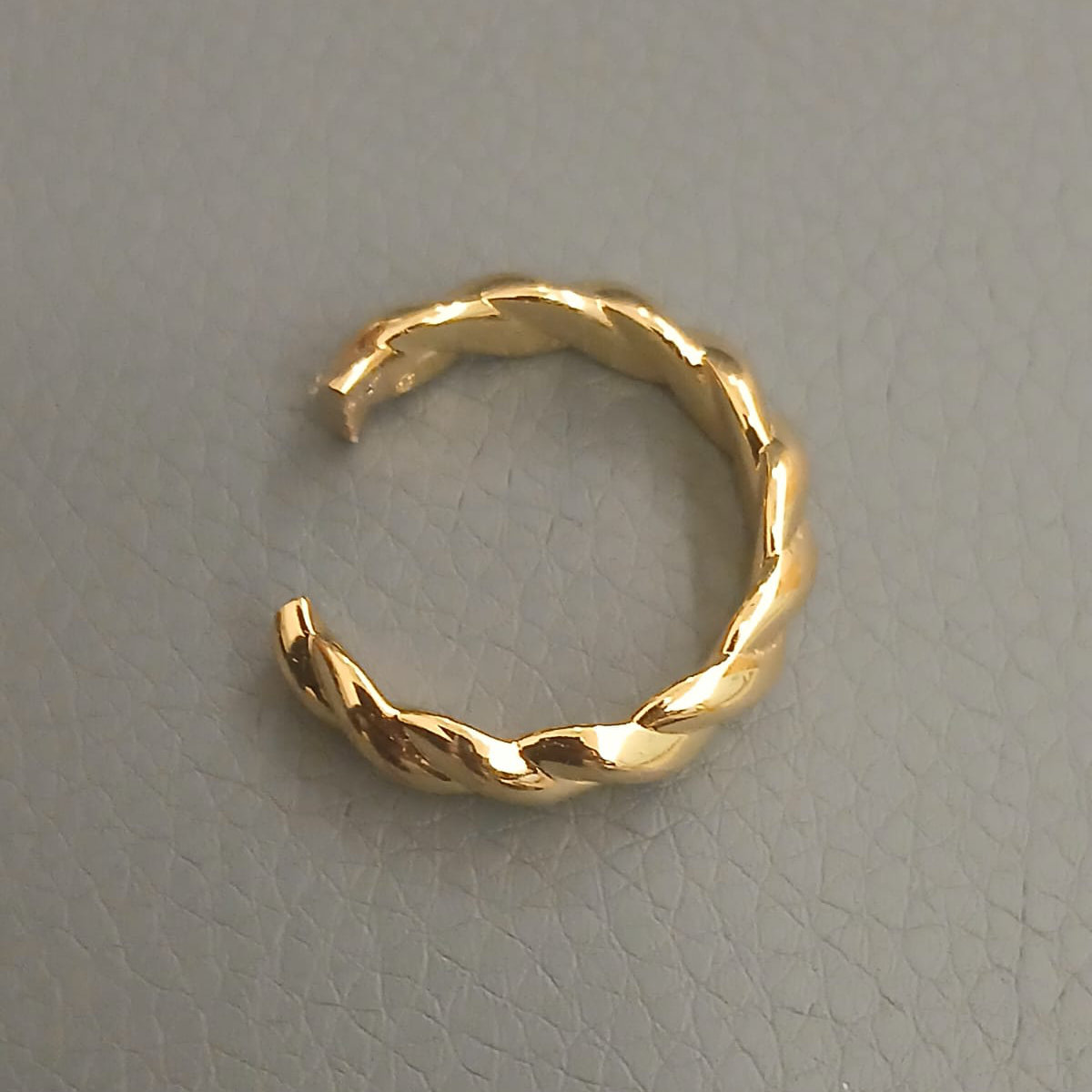 A gold wedding ring that has been cut off the finger, ready to be repaired and resized by a goldsmith