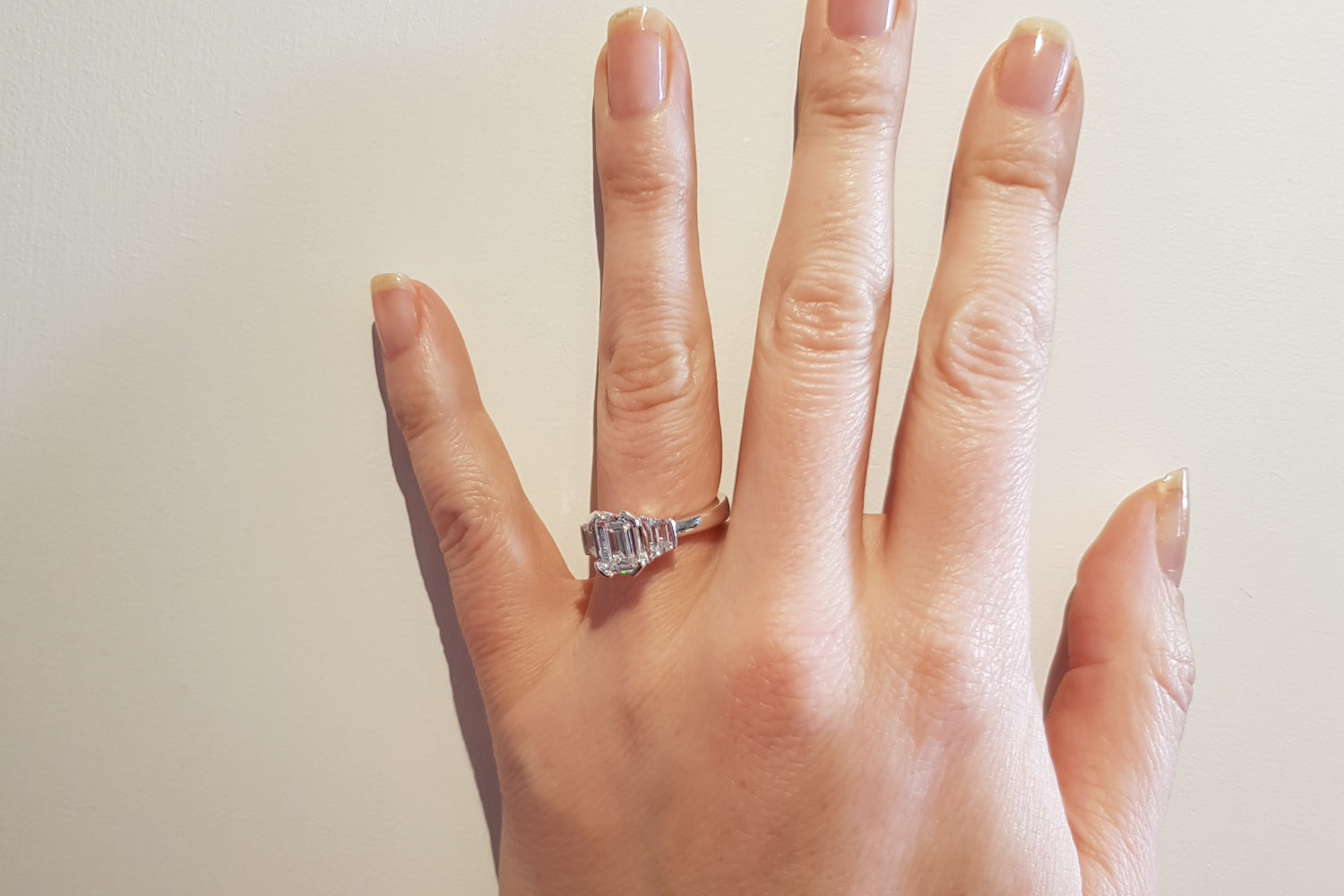 hand wearing an engagement ring that keeps slipping out of place