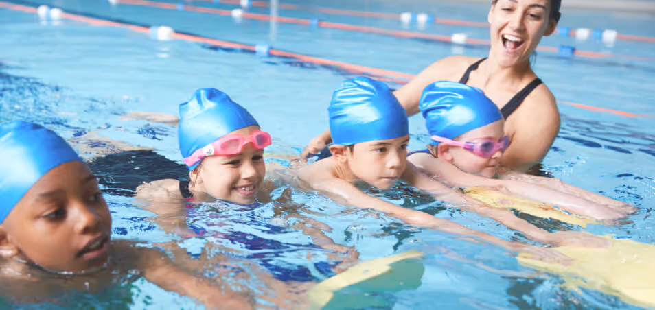 swim instructor and student during swim lessons in pool