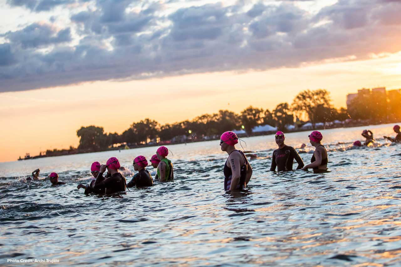 photo of the USTA triathlon race with swimmers in the water, photo credit Archi Trujillo