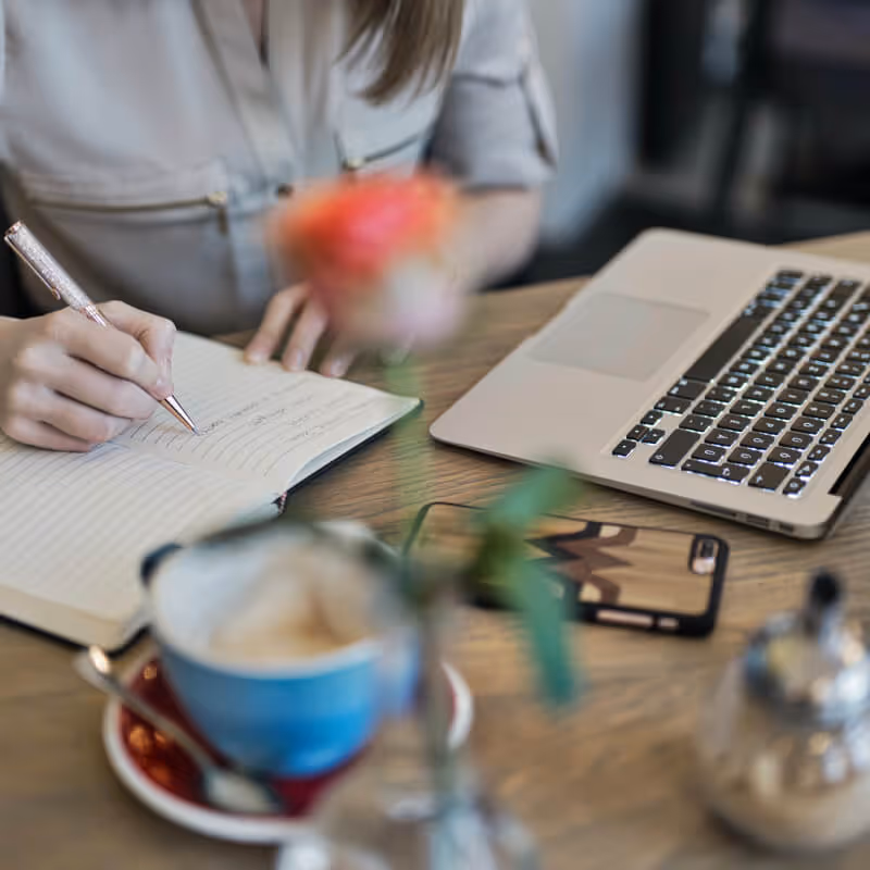 women on computer taking notes. Photo by Judit Peter from Pexels