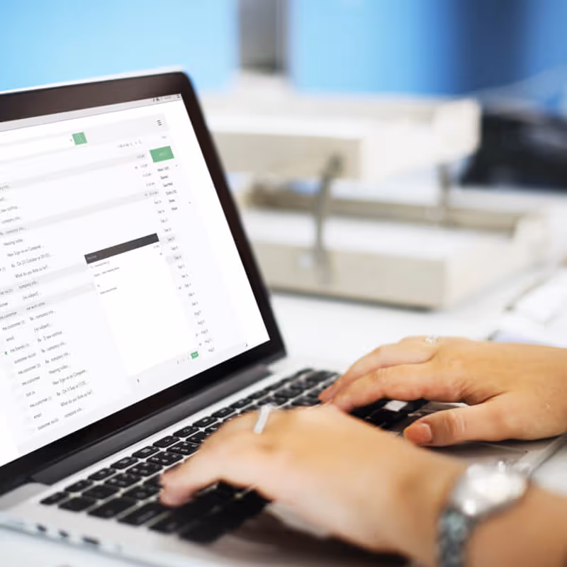 someone writing an email on the computer