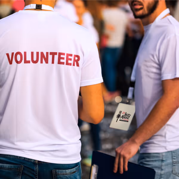 two volunteers working at an event