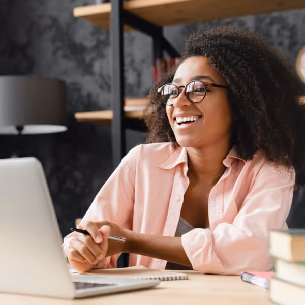 young woman watching The Summer Camp Society webinar pre-recorded