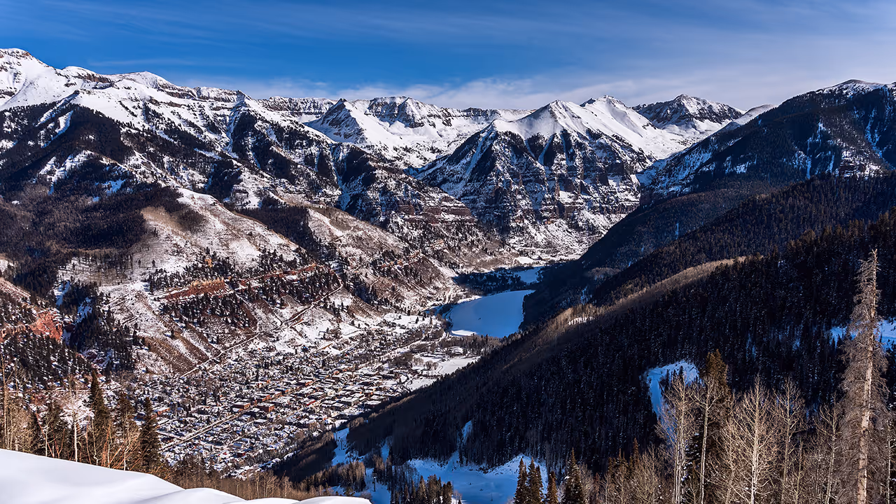scenic view of the town of Telluride from the mountains with snow
