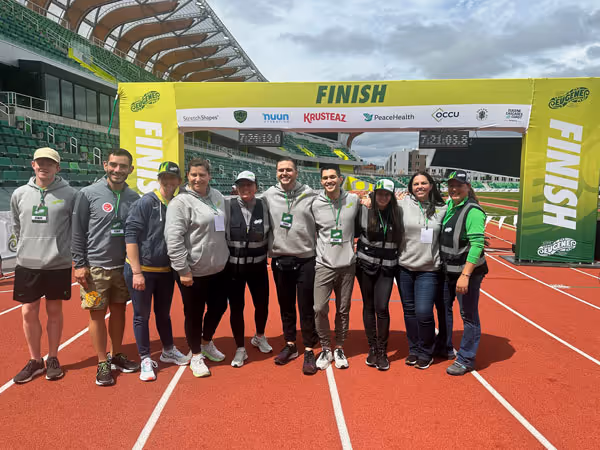 photo taken on a track at the finish line with 10 people