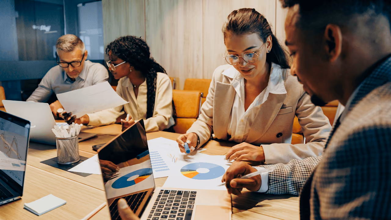 People looking at reports around a table