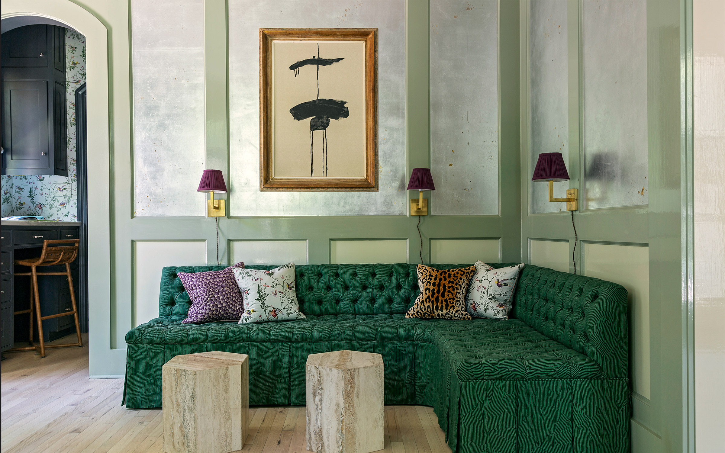 Colorful dining room with custom settee and foil wallpaper by interior designer Angie Hranowsky.
