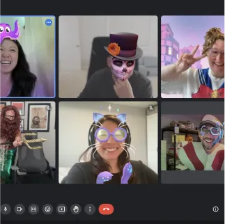 Six people in a video call using playful face filters including a purple elephant hat, skull makeup with a top hat, peace sign, mermaid holding a trident, cat ears and glasses, and a colorful striped hat and glasses.