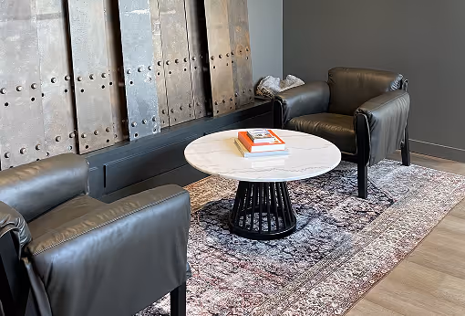 A living room with two chairs and a table.
