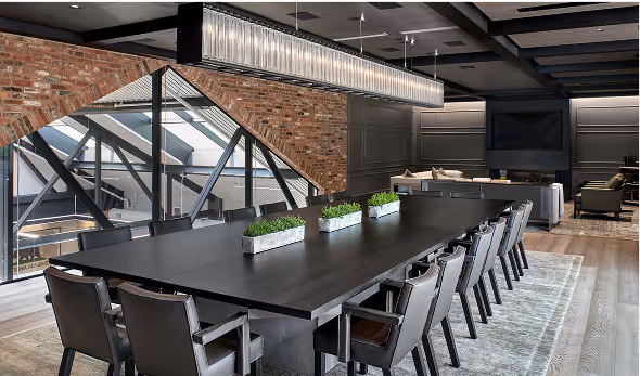 A dining room table with a planter on top of it.