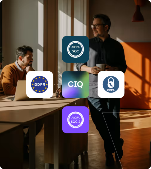 Two men in a sunlit modern office with overlay icons for GDPR, AICPA SOC, CIQ, CCPA, and AICPA SOC 2 compliance.