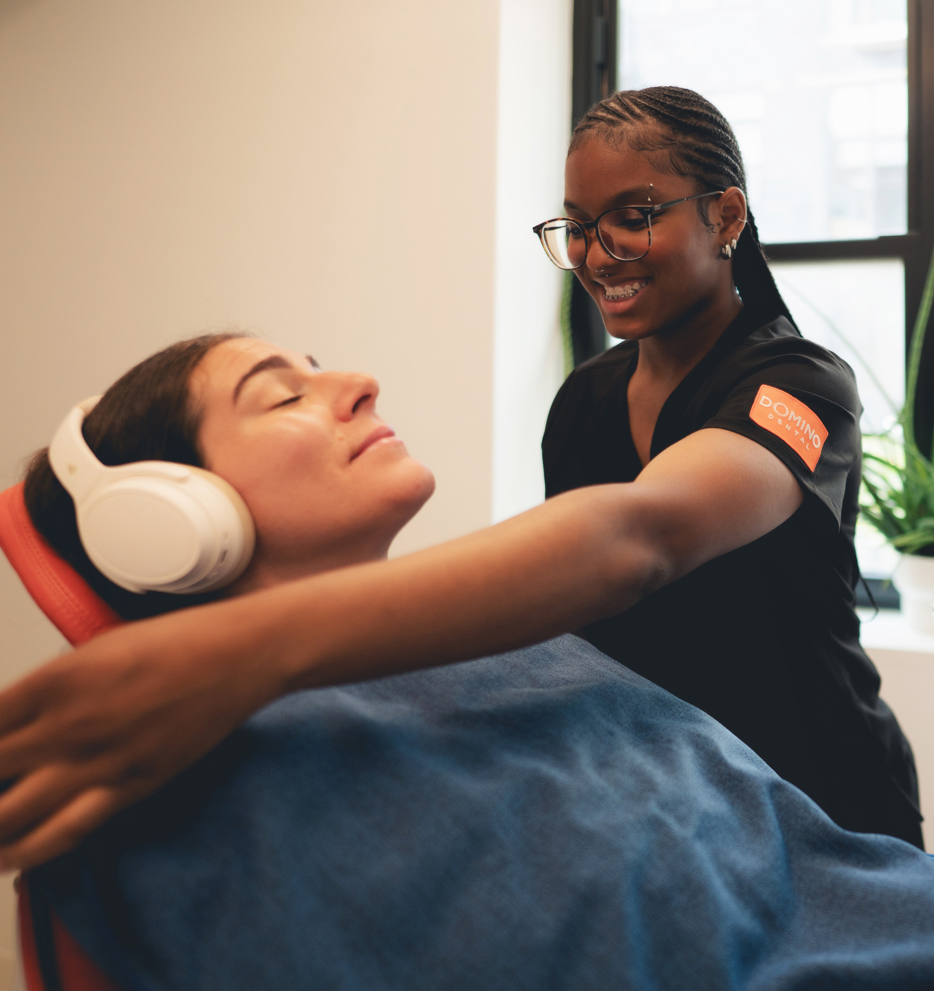 Photo of a man smiling with headphones on